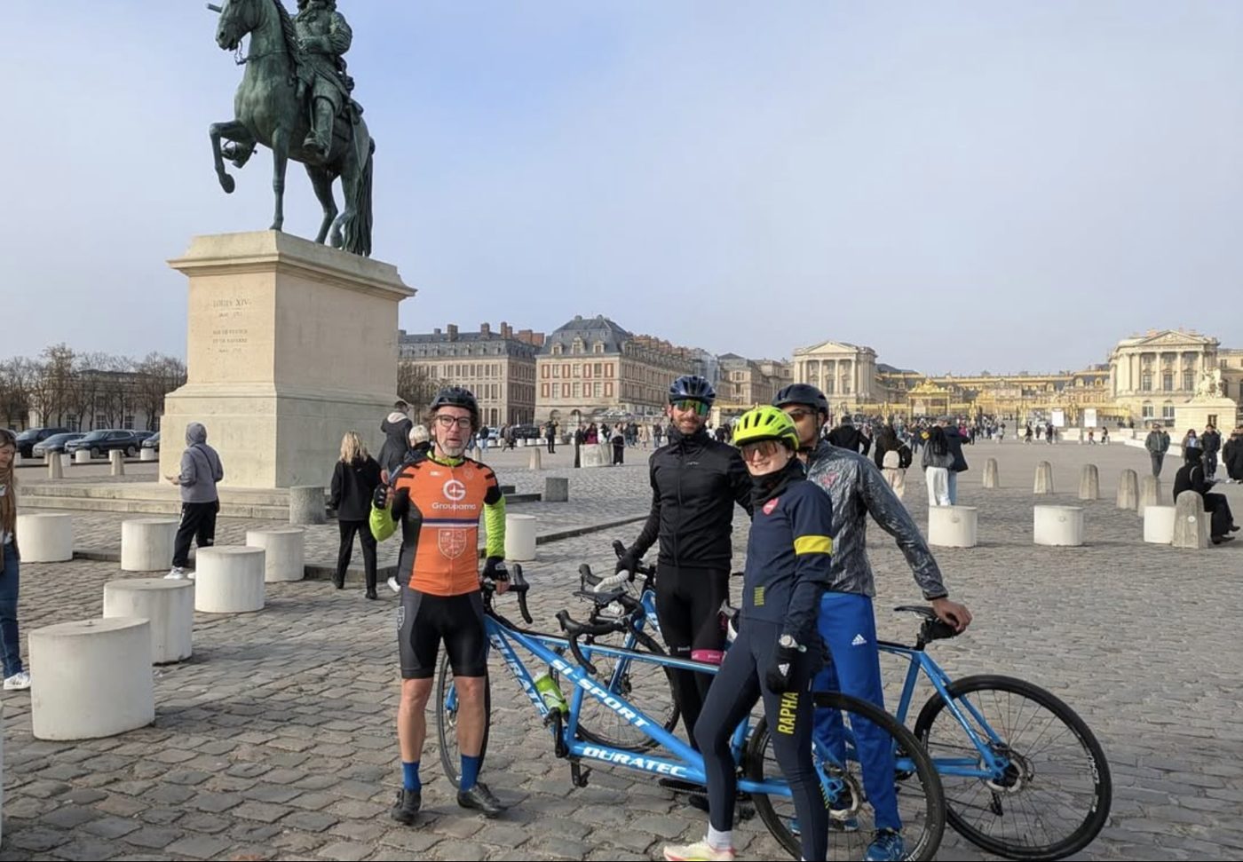 Cyclistes et tandem A2CMieux devant le château de Versailles.